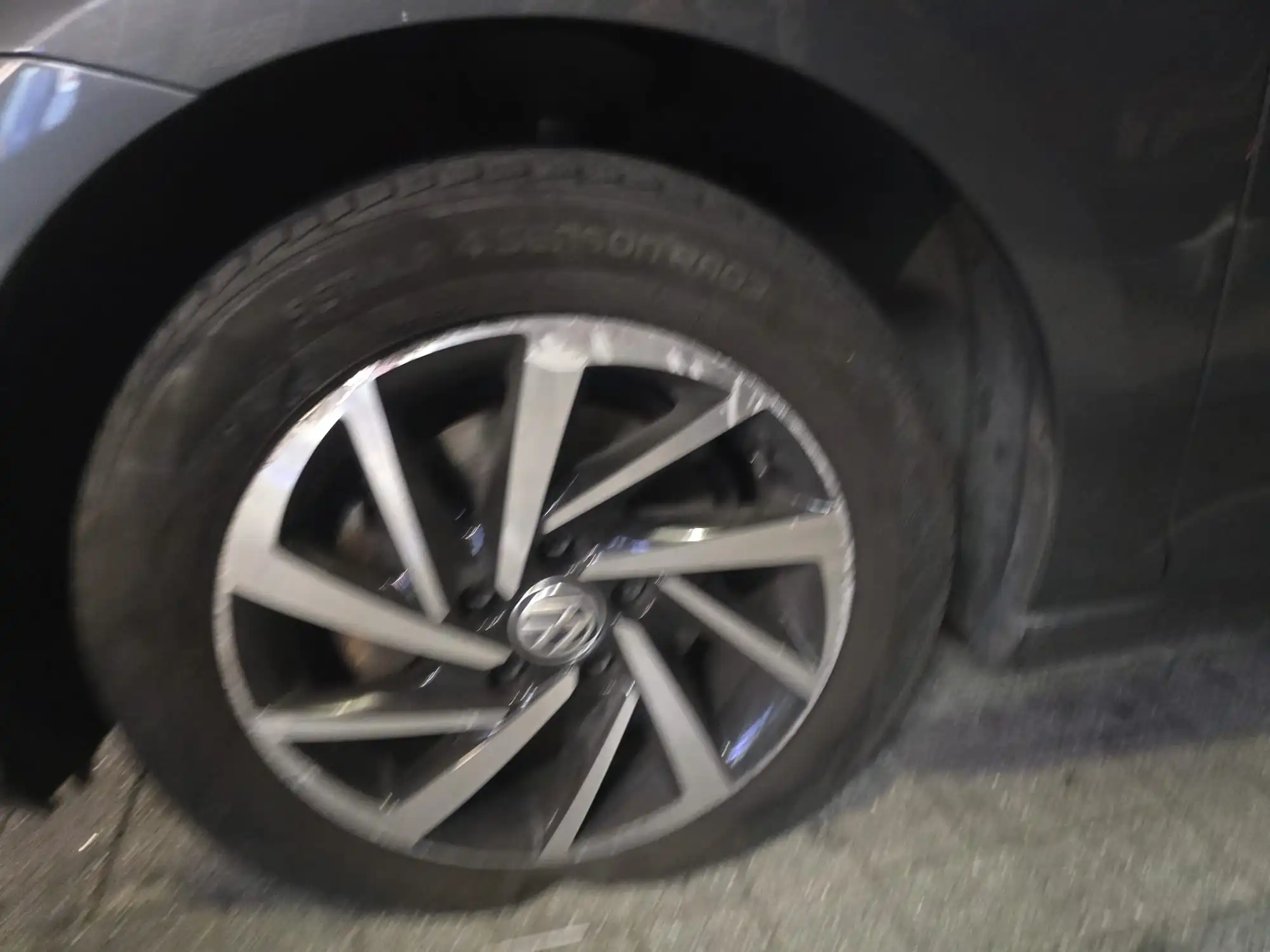 FlatFix technician checking car tyre tread depth in London
