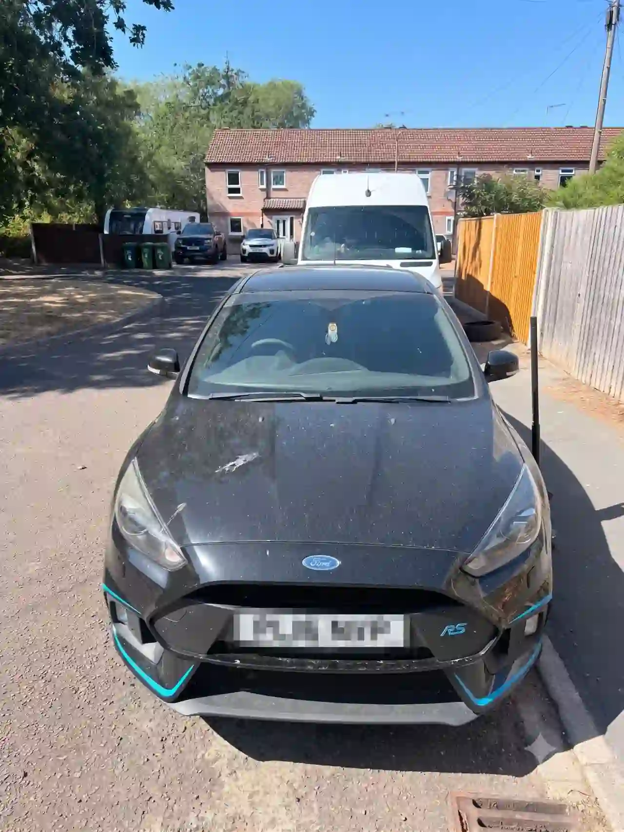 Car safely parked in a residential bay with clearance for mobile tyre fitting service van